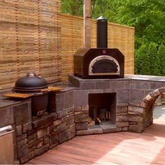 an outdoor pizza oven built into the side of a wooden deck