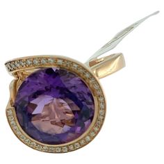 This IGI Certified Cocktail Ring is a true showstopper, exuding elegance and sophistication with its captivating design. Crafted from luxurious 18kt rose gold, it boasts a warm and romantic hue that complements the beauty of its gemstones. At the heart of the ring dazzles a stunning 13.00ct amethyst, radiating with a rich and vibrant purple hue. The amethyst serves as the focal point of the piece, drawing attention with its mesmerizing color and impressive size. Surrounding the amethyst are 40 s Luxury 14k Rose Gold Diamond Ring, Luxury Rose Gold Amethyst Ring With Center Stone, Luxury Vvs Clarity Amethyst Ring For Formal Occasions, Luxury Rose Gold Amethyst Ring For Anniversary, Luxury Rose Gold Amethyst Ring, Luxury Rose Gold Amethyst Ring With Prong Setting, Luxury Rose Gold Amethyst Ring As Gift, Elegant Amethyst Ring In Rose Gold For Anniversary, Formal Rose Gold Amethyst Ring With Center Stone