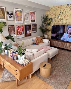 a living room filled with furniture and a flat screen tv mounted to the side of a wall