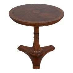 a round wooden table with an intricate design on the top and bottom, against a white background