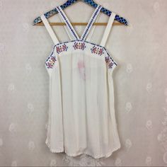 Nwt No Issues. Xhilaration White Lightweight Gauzey Strappy Sleeveless Blouse Tank Top Juniors Size Medium. Blue And Multicolor Embroidery Along Bust Line, Strap, And Cute Little White Balls Along The Bottom Hem. Length 27 In, Armpit To Armpit 16 In. White Tank Top For Beach Season, Stretch Sleeveless Blouse Camisole For Beach, White Stretch Camisole For Summer, White Camisole Tank For Vacation, Bohemian Tank Top For Summer Day Out, White Sleeveless Blouse Camisole For Summer, White Tank Camisole For Vacation, White Spaghetti Strap Tank Top For Summer, White Spaghetti Strap Summer Tank Top