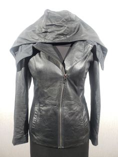 Charming women's leather jacket with a metal zipper. Mysterious black women's leather jacket with a hood. The jacket is made of strong, soft black genuine leather. The jacket is easily fastened with a metal zipper sewn diagonally. The jacket has two pockets at the bottom. The jacket has an amazing hood that can be folded over the shoulders. The jacket has a nice lining. The jacket is light and pleasant to wear. It has an unusual cut with charming elements that will emphasize your independence, confidence and mystery. MEASUREMENTS Jacket length                  61 cm  |  24 in Pit to pit                          47 cm  |  18.5 in Chest circumference       94 cm  |  37 in                                                            Waist circumference       82 cm  |  32.5 in Fitted Biker Jacket, Women Leather Vest, Black Leather Motorcycle Jacket, Womens Black Leather Jacket, Black Leather Biker Jacket, Sheepskin Coat, Black Leather Pants, Moto Style, Waist Circumference