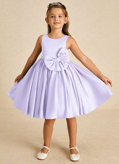 Apple showcases a lovely A-line silhouette in smooth matte satin. With a classic scoop neckline and sleeveless design, it features a stylish bow tie back and playful bows, making it an adorable choice for any whimsical celebration. Dresses With Bows, Satin Flower Girl Dresses, Lilac Flower Girl Dresses, Satin Flower Girl Dress, Bows For Girls, Military Ball Dresses, Sage Dress, Special Event Dresses, Lace Bride