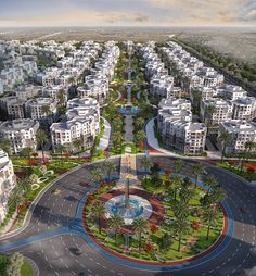 an aerial view of a city with lots of white buildings and palm trees in the foreground