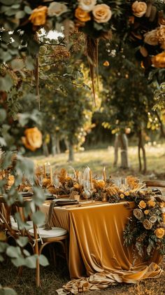 the table is set with yellow flowers and candles for an elegant dinner party or celebration