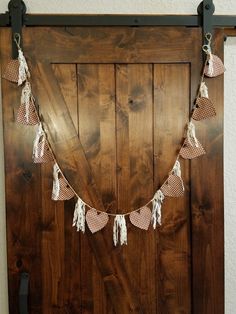 a wooden door with some tassels hanging from it