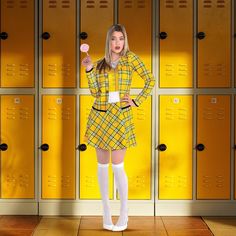 a woman standing in front of lockers holding a lollipop