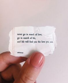 someone is holding up a piece of paper that says never go in search of love, go in search of life