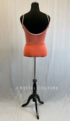 Salmon lycra camisole leotard is ruched at sternum and has a scoop back. Back of leotard and straps are Salmon velour. **Costume in image is an AL, Photographed on an AM/AL Mannequin with Measurements of: Bust 39", Ribcage 34", Waist 33", Hip 40", Girth 60" Camisole Leotard, Rib Cage, Leotards, Orange