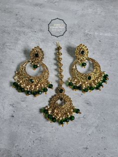 Overview Elevate your style with our stunning Green Maang Tikka and Earrings set, perfect for weddings, parties, and special occasions. This exquisite set is designed to make you feel special and stand out in any crowd. Shop now at Emro Collection! Product Features Elegant Design Our Green Maang Tikka and Earrings set features a sophisticated design that combines traditional elements with modern flair. The intricate detailing and vibrant green color make it a standout piece. High-Quality Materia Hand Set Bridal Sets For Festive Party, Green Hand-set Chandbalis For Party, Hand Set Chandelier Earrings For Parties And Festivals, Hand Set Chandbalis For Diwali Party, Green Bridal Earrings For Diwali Party, Green Tilla Chandbalis For Party, Festive Green Chandelier Earrings For Party, Green Bridal Earrings For Wedding Eid Festival, Green Bridal Earrings For Party