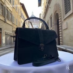 This bag has been made of the best genuine leather by local master crafters of Florence in Italy, designed for women who only accept premium Italian quality and luxury leather bags and modern Italian fashion. . Sizes: Width: 29cm/10.6 inch Height: 19cm/7.4 inch Depth: 7 cm/3.9 inch Color: Black . The story of this bag:  John was visiting Florence with his family and he wanted to find the perfect gift for his wife and daughters. He had heard about the exquisite leather craftsmanship in the city a Black Briefcase With Detachable Handle, Elegant Leather Flap Bag For Daily Use, Black Rectangular Leather Backpack, Black Top Handle Flap Bag For Daily Use, Black Leather Backpack With Leather Lining, Formal Leather Flap Bag With Leather Handles, Black Rectangular Shoulder Bag With Leather Lining, Black Satchel With Leather Lining For Daily Use, Elegant Leather Handled Flap Shoulder Bag