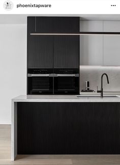 a kitchen with black cabinets and white counter tops