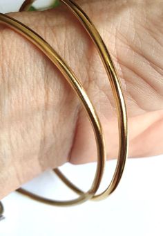 Bangle bracelet, gold bangle bracelet for women, gold bracelet, minimalist bracelet, basic bangle, stacking bracelets, simple gold bracelets A minimalist, gold bangle bracelet, simple but chic, created from a 2.5mm wire which was soldered and plated with nickel free, 14k gold plating. The bangle can be worn by itself or stacked together with similar or different bangles in my shop. These stacking bangle bracelets are a perfect gift for teens and women. Dimensions: The gold bangle bracelet is 2.5mm thick (0.1 inches) and is available in 3 different sizes: Small (S), Medium (M) and Large (L). Small - diameter of 6 cm (or 2.35 inches) Medium - diameter of 6.3 cm (or 2.5 inches) Large - diameter of 7 cm (or 2.75 inches)  Can be made in different sizes upon request. Just convo me for pricing. T Gold Minimalist Cuff Bracelet, Gold Plated, Minimalist Gold Cuff Bracelet For Everyday Wear, Minimalist Stackable Gold Cuff Bracelet, Gold Stackable Brass Bangle, Gold-plated Gold Bangle For Everyday, Minimalist Gold Stackable Cuff Bracelet, Everyday Gold Minimalist Cuff Bracelet, Minimalist Gold Hoop Bracelet, Minimalist Yellow Gold Brass Cuff Bracelet