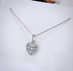 Delicate and elegant, this heart necklace will add a touch of sophistication to any wedding gown or formal ensemble. Adorned with heart-shaped cubic zirconia that captures the light from every angle with a perfectly translucent appeal, the necklace is rhodium / rose gold plated for a flawless finish which perfectly enhances the intricate detailing and conveys a modern take on old elegance. Length: 16" (approx. 40.6cm) with a 2" (approx. 5cm) extension for comfortable sizing. Available in Silver Bridal Necklace, Heart Jewelry, Wedding Gown, Heart Necklace, Rose Gold Plates, Wedding Jewelry, Silver Gold, Diamond Necklace, Heart Shapes