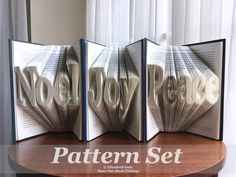 three folded books with the words no more on them