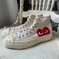 Wear Your Heart On Your Shoes With The Converse X Comme Des Garons Play Chuck 70 Sneaker. This Street-Ready Style Features The Premium Chuck Details You Know And Love, Paired With A Whimsical Heart-And-Eyes Graphic Peeking Just Above The Sole. Eye-Catching Is An Understatement. Why You Should Be Down: -Canvas Is Lightweight And Durable. -Tonal Rubber Toe Cap And Contrasting Heelstay For Standout Style. -Lace-Up Design For A Snug Fit. -Vulcanized Rubber Sole For Increased Traction. -Signature Hea Cgd Hearts, Streetwear High-top Sneakers With Vulcanized Sole, Flat Canvas Sneakers With Vulcanized Sole, Flat Vulcanized Canvas Sneakers, Flat Canvas Sneakers For Streetwear, Casual Slip-on Sneakers With Medium Fit, Casual Medium Fit Slip-on Sneakers, Custom Canvas Sneakers With Boost Midsole, Custom Casual High-top Converse Sneakers