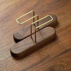 a wooden table with a metal object on it's side and a wood surface