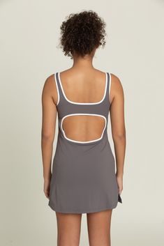 Our Charcoal Open Back Active Dress is the perfect blend of style and performance. Made with a soft and breathable fabric, it effortlessly takes you from brunch to the pickleball court. Built in spandex shorts with hidden pockets to hold your essentials, and a built in bra with removable padding to give support when you need it. Oh and did we mention it's open back? You're welcome. Sporty Tennis Activewear With Built-in Bra, Fitted Tennis Activewear With Built-in Shorts, Sporty Tennis Dress With Built-in Shorts For Workout, Athleisure Tennis Dress With Built-in Shorts, Fitted Athleisure Tennis Activewear, Athleisure Tennis Dress With Built-in Shorts For Sports, Sporty Tennis Dress With Built-in Bra For Gym, Casual Moisture-wicking Tennis Dress For Sports, Athleisure Mini Length Tennis Dress For Gym