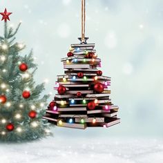 a christmas tree made out of books with lights on it and a star hanging from the top