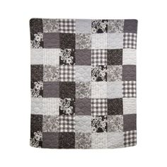 a black and white patchwork quilt on a white background with an image of flowers in the center