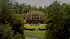 a large house surrounded by trees and bushes