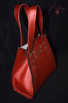 Bogo Leather Handbag, a mini classic purse made of American chrome tanned Cowhide leather and polished with top coat to make it resistance to water. The interior part of the bag is logo printed on lining. Inside the purse there is one small flat pocket. Bottom of the bag is supported by 4 supportive and protective metal feet. The bag opens and closes easily with magnetic snap on top.  Length x Height x Width  7 X 7 X 3.5 Handle (s) drop size: 4 inches Color: Starry ruby red Material: American ch Luxury Small Bag With Removable Pouch, Small Luxury Evening Bags, Small Luxury Evening Bag, Luxury Small Bags For Everyday Use, Luxury Small Bag For Everyday Use, Red Leather Box Bag, Elegant Small Bag For Everyday Use, Elegant Small Evening Shoulder Bag, Small Elegant Bag For Everyday Use