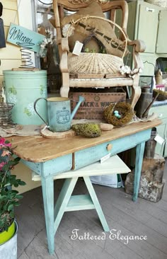 an old wooden table topped with pots and pans filled with birds nest eggs on top of it