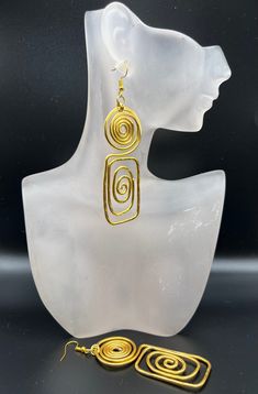 a pair of gold - plated earrings with spiral design on the front and back