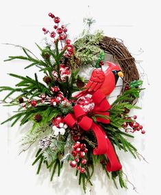 a christmas wreath with a cardinal on it