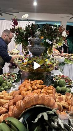 a buffet table filled with croissants and other foods