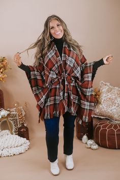 The Cozy Things Poncho is featured in a flattering poncho style fit, with a plaid design, adjustable tie waistline, raw hem, and a lightweight layer-able fabrication. Perfect for so many occasions. Open front with adjustable tie design Plaid design Poncho style sleeve Raw hem Rich color tones Fabric: 100% Acrylic Model Specs: Karli is wearing the O/S in the photo.How will this item fit you? Check out our MODEL SPECS (Typical Sizing - Karli: S-Size 5/26 - 5ft 2in, Emily: S-Size 3/25 - 5ft 5in, Sy Cozy Things, Plaid Poncho, Vip Group, Everyday Chic, Tie Design, Poncho Style, Color Tones, Poncho Cape, Plaid Design