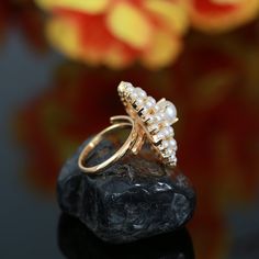 This stunning Gold Polish Pearl ring is ideal for special occasions. Crafted with CZ American Diamonds, Ruby, Emerald, and a large Floral design, it is an eye-catching yet timeless accessory for weddings or other formal events. The beautiful design adds style, personality, wealth, and status. Perfect for traditional Indian outfits like sarees, these rings are perfect for Indian, Pakistani, or Bollywood themed events. Floral Design Wedding, Statement Rings Diamond, Traditional Indian Outfits, Gold Statement Ring, Ruby Emerald, Themed Events, Party Rings, Kundan Necklaces, Cz Jewelry