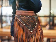 Do you want a bohemian style? with our stunning hobo fringe leather bag, expertly crafted from high-quality sheepskin leather and decorated with cute fringe details with engraved hand tool leather. This hobo bag features a comfortable shoulder and cross body strap, making it perfect for both casual and any occasions.  Its unique design handmade bag not only adds a bohemian touch to any outfit, but will make you different with others. It's time to get this fringe bag on your closet or you can gif Bohemian Leather Hobo Bag For Fall, Leather Fringe Hobo Bag For Festivals, Artisan Brown Bag With Fringe, Brown Artisan Bags With Fringe, Artisan Brown Bags With Fringe, Bohemian Shoulder Bag With Tassels For Fall, Artisan Brown Fringe Bag, Bohemian Fall Bags With Tassels, Artisan Leather Shoulder Bag With Fringe