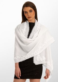 This luxurious ivory scarf is crafted from the finest cashmere offering both comfort and style. The hero of this scarf is a stunning border of three-dimensional roses, delicately hand-embroidered from a tonal ivory ribbon. This intricate handcrafted detailing captures the essence of classic sophistication and will surely elevate the look of any ensemble, whether draped casually or adorned to enhance a more formal look. This is a unique masterpiece and a must-have for any wardrobe. Elegant White Embroidered Shawl, Elegant White Shawl With Floral Embroidery, Elegant White Embroidered Scarf, Rose Border, Ribbon Rose, Ribbon Roses, Silk Embroidery, Formal Looks, Cashmere Scarf