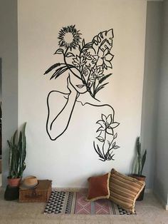 a wall with a drawing of a woman and flowers on it