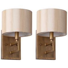 two wall lamps with beige shades on them