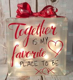 a lighted glass block that says together is my favorite place to be