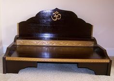 a wooden bed frame sitting on top of a carpeted floor next to a wall