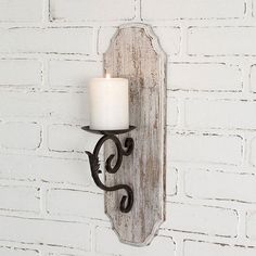 5¾"W x 7"D x 17½"H. Hangs with a D-ring hanger. Shown with a 3" candle, not included. Measurement: 5¾''W x 7''D x 17½''H UPC: 801106175452 Wood Pillar Candle Holders, Farmhouse Candle, Wrought Iron Candle Holders, White Wood Wall, Farmhouse Candles, Wrought Iron Candle, Antique Booth, Turning Projects, Large Candle Holders