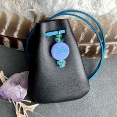 "Lotus Flowers adorn a Czech Glass Bead accented with Healing Gemstone Beads. Vegan Eco Leather Medicine Bag, Shaman Bag or Amulet Pouch to wear around your neck-or hang in your Car! Perfect for Ceremony, or to keep on your Altar. Unique and Beautiful Gift . A place for things that have Spiritual Meaning for you-like that pretty rock your 3 year old gave you.... ....And it happens to fit EarPods too....or better yet,your Prayer Beads! 3 3/4\"deep 2 3/4\"wide strap is cut out about 38\" Choice of Mobile Phone Clutch Pouch, Beaded Pouch Shoulder Bag For Gift, Beaded Pouch Shoulder Bag As Gift, Handmade Bags For Daily Use, Beaded Everyday Bag, Leather Medicine Pouch, Lotus Meditation, Necklace Pouch, Crystal Pouch