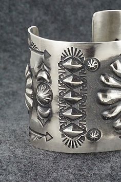 This stunning sterling silver bracelet was made by Navajo silversmith Elvira Bill. The inside is signed Elvira Bill and stamped sterling.Size: 5 7/8" (will fit up to a 7 1/4" wrist)Gap: 1 3/8"Width: 2"Free shipping on all orders! We ship with USPS and always include tracking. All orders ship within a day of payment.Returns are accepted up to 30 days after you receive your order. Just send us a message. Our shop offers cash back or store credit. The item must be returned in new condition. Artisan Silver Bracelet With Stamped Details, Sterling Silver Southwestern Bracelet With Polished Finish, Artisan Sterling Silver Concho Cuff Bracelet, Artisan Sterling Silver Bracelet With Etched Details, Southwestern Sterling Silver Cuff Bracelet In Silver, Southwestern Silver Bangle Jewelry, Silver Cuff Bracelet With Stamped Details, Unique Silver Stamped Cuff Bracelet, Artisan Silver Concho Cuff Bracelet