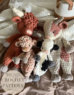 three crocheted stuffed animals on a bed