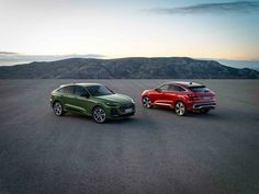 two red and green suvs parked in an empty lot