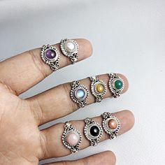 Solid 92.5% Sterling Silver Handmade Ring With Semi Precious Cabochons Gemstones Gemstone - Gemstone Size - 6 mm Ring Size :- A - 6.5 US ( Amethyst ), B - 6 US ( Pearl ), C - 9 US ( Pink Opal ), D - 8 US ( Sun Stone ), E - 8 US ( Green Onyx ), F - 7.25 US ( Black Onyx ), G - 9 US ( Rainbow Moonstone ), H - 9 US ( Tigereye ) QTY - 1 piece in this listing. We are manufacturer of silver jewellery , silver findings and gemstones . We manufacture all the at our factory with our skilled workers that l Bohemian Silver Crystal Ring In Sterling Silver, Bohemian Sterling Silver Crystal Ring, Silver Bohemian Moonstone Ring, Bohemian Silver Sterling Crystal Ring, Adjustable Moonstone Jewelry With Round Stone, Natural Round Stone Jewelry For Jewelry Making, Round Natural Stones For Jewelry Making, Natural Round Stones For Jewelry Making, Bohemian Silver Sterling Silver Opal Ring