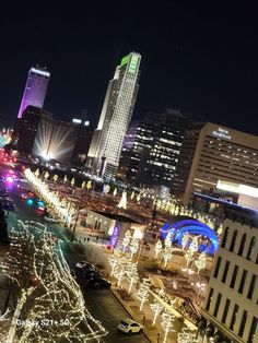 the city is lit up with christmas lights