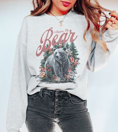 ♡ Welcome to Moxie & Bloom! Add some humor to your wardrobe with our I Choose the Bear Vintage Graphic Sweatshirt from Moxie & Bloom! This comfy Gildan 18000 sweatshirt features a vintage-inspired graphic of a bear in the forest with the cheeky phrase "I choose the bear," referencing a popular meme. With its soft, cozy feel, this meme sweatshirt is perfect for nature enthusiasts, movie lovers, and anyone with a great sense of humor. Whether you're out exploring or just lounging at home, this shi Winter Bear Print Cotton Top, Winter Cotton Top With Bear Print, Graphic Tee With Bear Print And Crew Neck, Fall Bear Print Crew Neck Top, Bear Print Crew Neck Top For Fall, Casual Bear Print Tops For Fall, Bear Sweatshirt, This Meme, Movie Lover