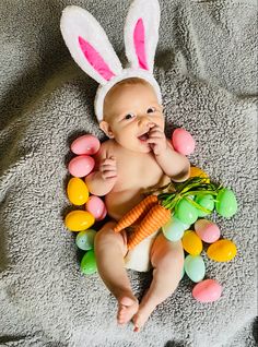 First Easter Photoshoot. Baby in a pile of eggs with bunny ears on. Easter Photoshoot Baby 3 Months, Diy First Easter Pictures, Diy Easter Baby Photos, Newborn Easter Pictures At Home, Easter Boy Photoshoot, Diy Newborn Easter Pictures, Easter Infant Photoshoot, At Home Easter Photoshoot Baby, Easter Baby Boy Photoshoot