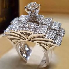 a close up of a diamond ring on a table