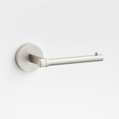 a white toilet paper holder with a metal bar on the side and a round handle