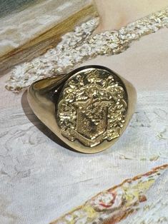 Thank you for viewing Wrenn Estate  Size 6 1/4 Beautiful, high relief signet ring with a family crest featuring a swan, a knights helmet, and two Fleur de Lis on the shield. With British hallmarks for 18 karat London 1959 10.43 grams 18k yellow gold  15 x 13mm oval top  3mm wide at back  See photo with ruler for size  Vintage jewelry has been worn and may show signs of wear. Please review the pictures to examine the jewels size and condition. All fasteners and clasp are working unless otherwise noted Luxury Red Heirloom Signet Ring, Luxury Victorian Formal Signet Ring, Luxury Antique Engraved Ring For Commemoration, Gold Signet Ring Vintage, Luxury Engraved Ring With Coat Of Arms For Gift, Luxury Engraved Signet Ring Collectible, Classic Ceremonial Signet Ring With Polished Finish, Classic Hallmarked Signet Ring For Collectors, Classic Hallmarked Signet Ring Collectible